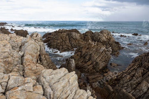 Preview: Rocky jagged coastline, eroded sandstone rock, view out to the ocean