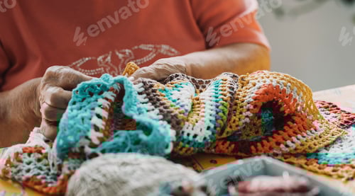 Preview: Close up of old mature woman hands working with crochet and sewing thread. Elderly indoor.