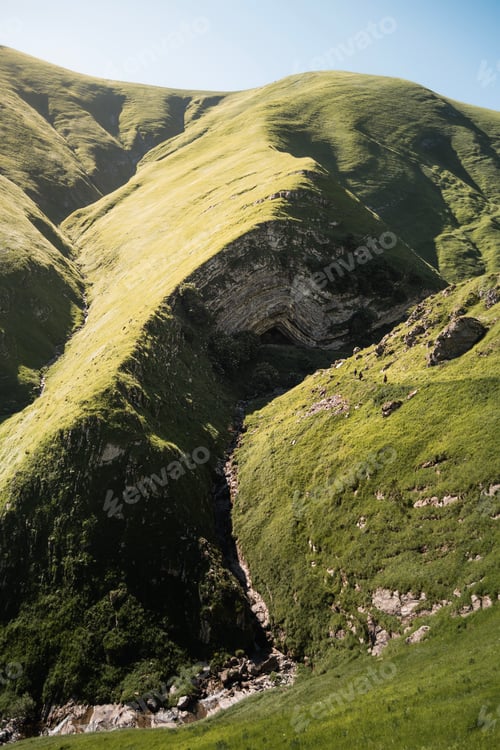 Preview: A green valley and a natural cave in the heart of the Pyrenees during summer.
