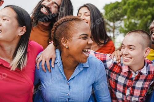 Preview: Group of young multiracial friends having fun together while hugging each other at city park