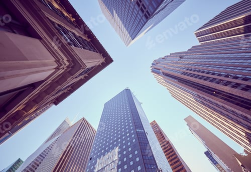 Preview: Looking up at New York skyscrapers at sunset, USA.