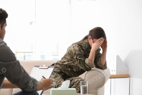 Preview: Psychotherapist working with female military officer in office