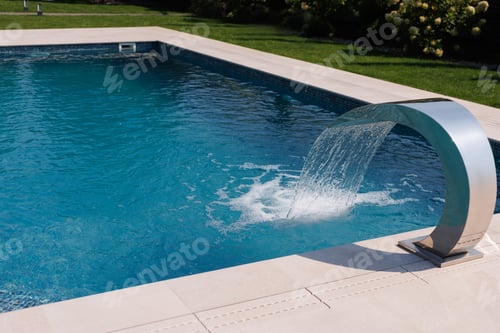 Preview: Luxury outdoor swimming pool with a modern stainless steel waterfall feature, elegant summer vibe.