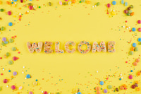 Preview: Colorful Cookie Letter Welcome on Yellow Background