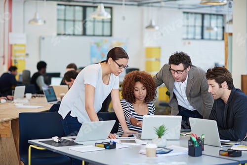 Preview: Brainstorming solutions. Cropped shot of business people working on laptops around a table.