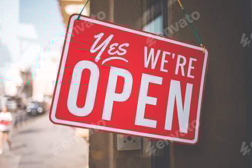 Preview: yes we're open sign on the glass of the doors in store. welcome sign at the store