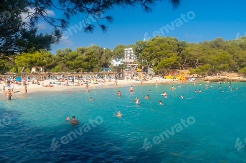Preview: Tourists enjoying summer holidays at beautiful cala s'amarador beach in mallorca, spain