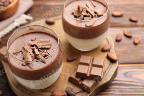 Preview: Delicious panna cotta with chocolate and cocoa beans on wooden table, closeup