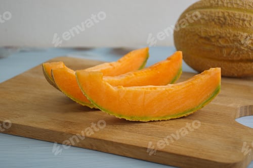Preview: Orange melon sliced on the cutting board