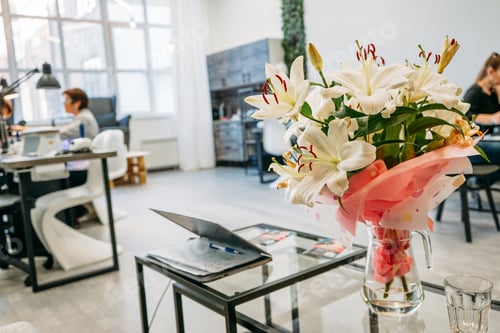 Preview: Bouquet of white lilies on the background of nail bar beauty salon, small business