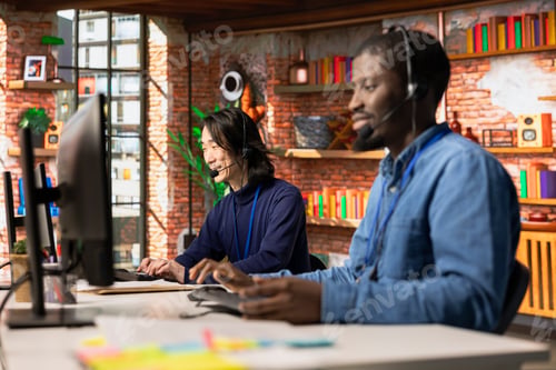 Preview: Multiracial workers in diverse call center office creating support tickets