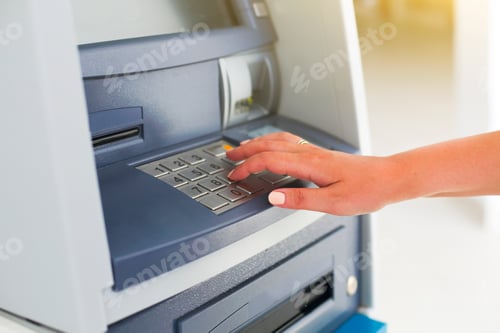Preview: Young tourist woman using banking machine