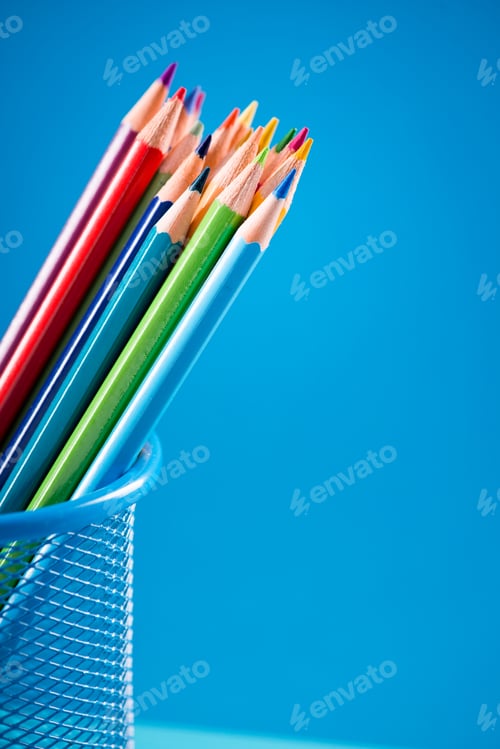 Preview: Colorful pencils in blue basket holder