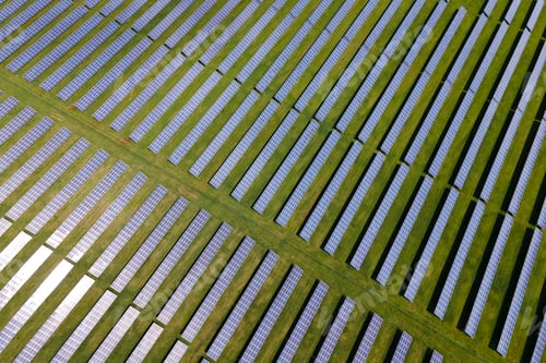 Preview: Aerial view of big sustainable electric power plant with many rows of solar photovoltaic panels