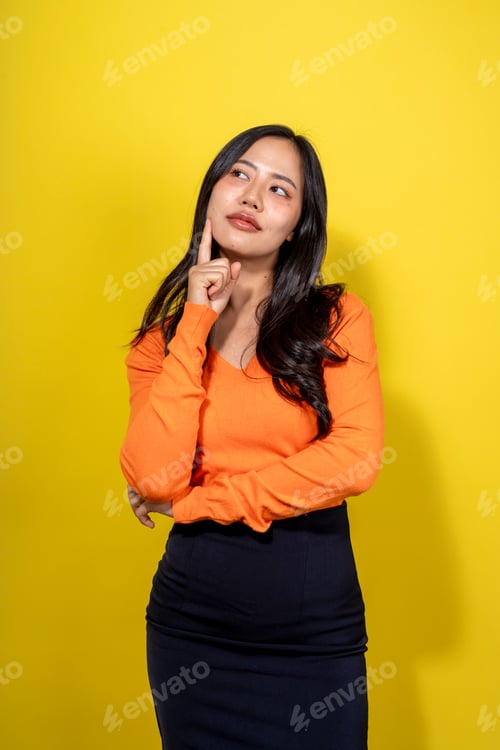 Preview: A woman in an orange shirt and black skirt is looking to the right