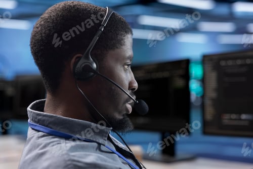 Preview: Man at work talking in headphones microphone with on field technicians
