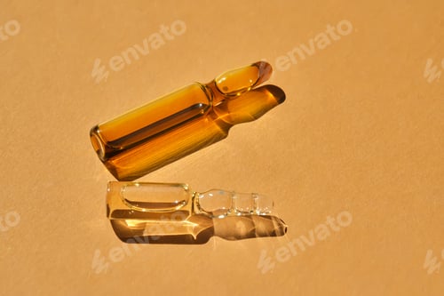 Two Pharmaceutical Vials on a Brown Surface