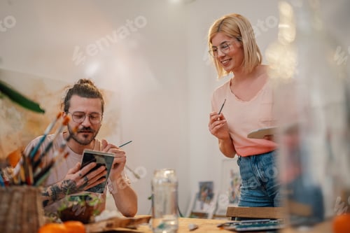 Preview: Creative artist smiling and preparing for painting at artistic studio.
