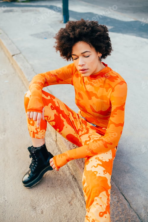 Preview: Young black curly hair woman posing outdoor carefree cool attitude