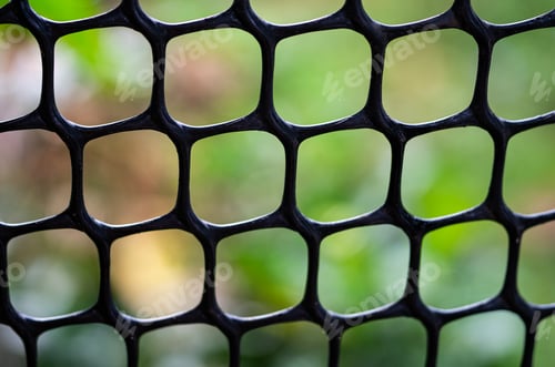 Preview: Close-Up of Plastic Netting Against Natural Background