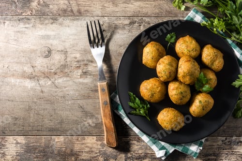 Preview: Traditional cod fritters decorated with garlic and parsley