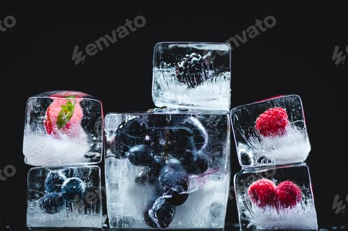 Preview: close-up view of gourmet frozen fruits in ice cubes on black
