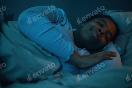 Preview: Sleeping African American Woman Smiling Peacefully on Pillow