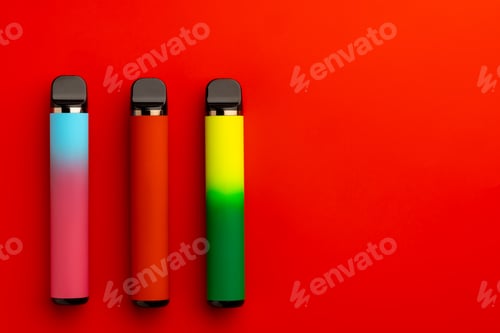 Preview: Disposable electronic cigarettes on red background close up