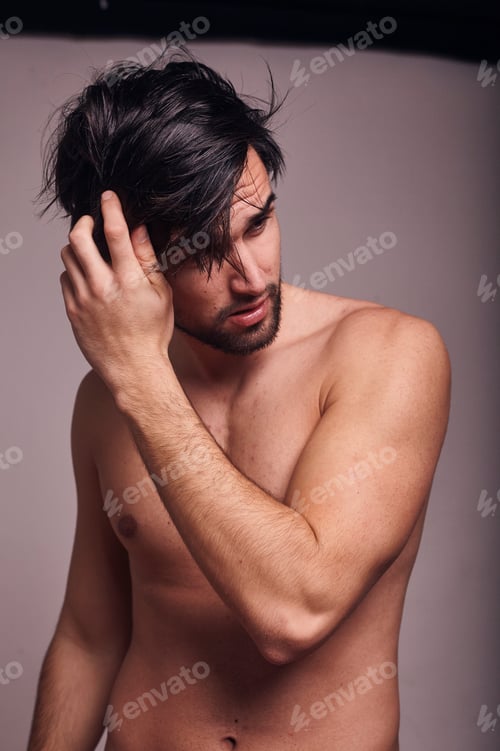 Preview: One Young Man Shirtless, Messing With His Hair, Looking Away From Camera.