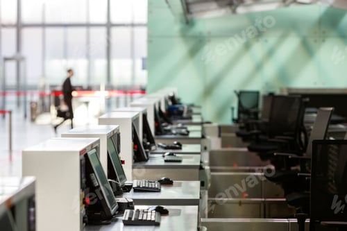 Preview: Row of check-in desks with computer monitors at empty airport due to coronavirus pandemic Covid-19