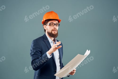 Preview: Male engineer with blueprints in the hands of an orange hard hat Industry professional