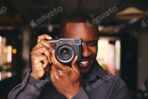 Preview: Photographer Taking A Picture With Camera Looking Through Lens