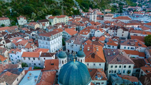 Preview: Aerial view of Kotor's charming rooftops and historic architecture during golden hour