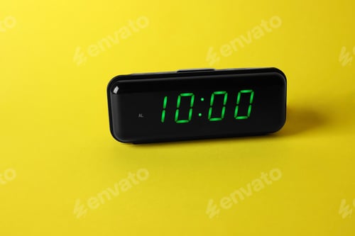 Preview: Digital alarm clock showing 10:00 o'clock on yellow background, space for text