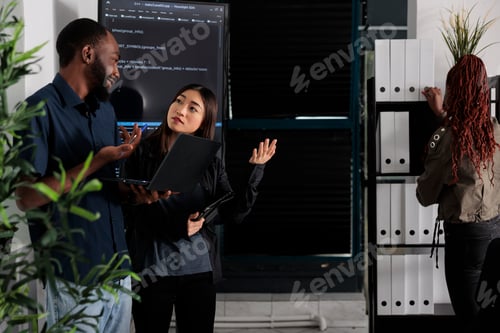 Preview: Diverse team of programmer analyzing html code on laptop