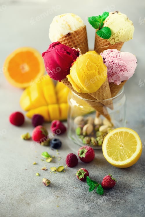 Preview: Colorful red, pink, yellow, green, white ice cream balls in waffle cones with different flavors -