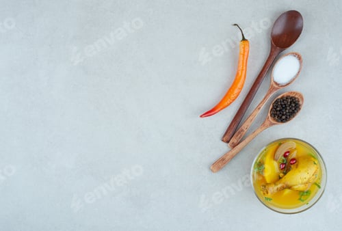 Preview: Tasty soup with spices and chili pepper on white background