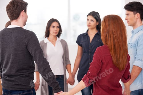 Preview: Trust circle. Group of people standing in circle and holding hands