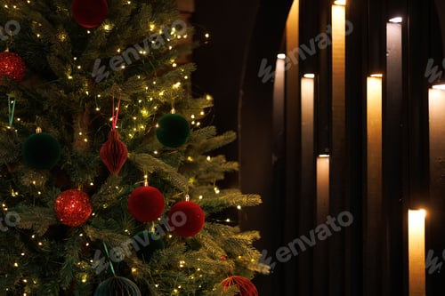 Preview: Close-up of a Christmas tree with red balls and bokeh in the background.