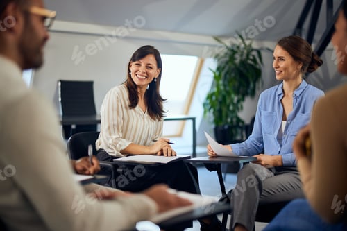 Preview: Focus on the two females talking to the group during psychotherapy.