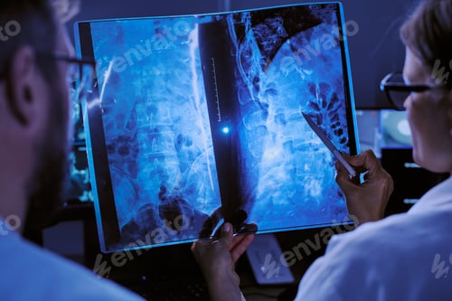 Preview: Two Middle Aged Caucasian Doctors Analyzing X Ray Scan in Hospital Setting