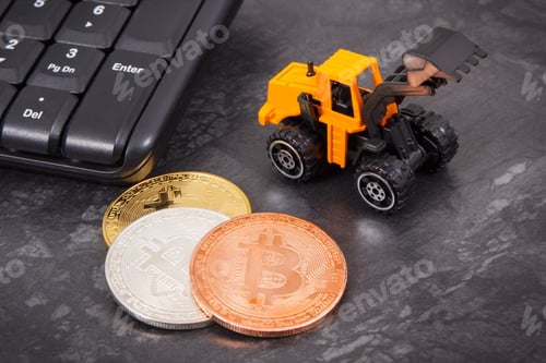 Preview: Bitcoins as symbol of electronic virtual money, miniature excavator and computer keyboard