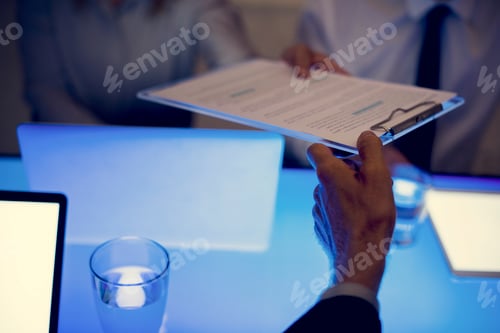 Preview: Hand passing a clipboard with document to another