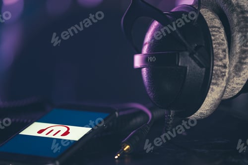 Preview: Musical background with a phone and headphones on a dark background.