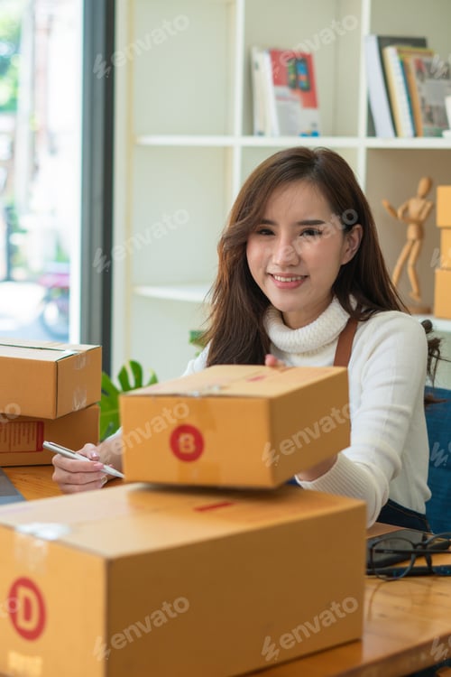 Preview: Starting small businesses SME owners female entrepreneurs check online orders to prepare to pack the