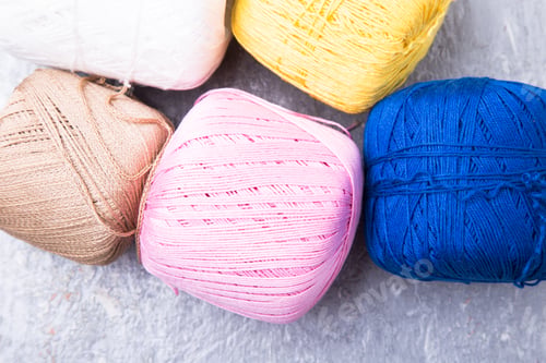Preview: Multicolor knitting ball and needles on grey background. Top view. Copy space. Knitting yarn.