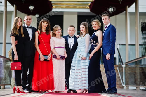 Preview: Group of good-looking graduates posing on the graduation day next to the restaurant.