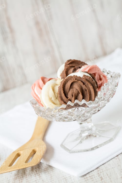 Preview: Chocolate Vanilla And Strawberry Spritz Cookies In Antique Glass Bowl With Wood Spatula