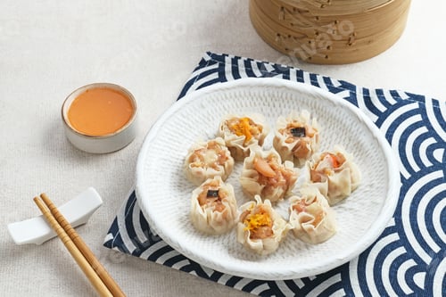 Preview: Dumplings Served on Plate with Dipping Sauce