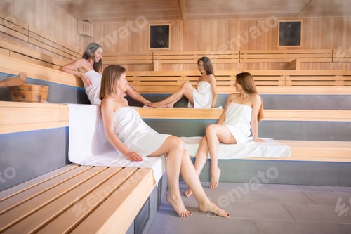 Preview: Group of girlfriends while relaxing in the sauna cheerful talks and spa treatment